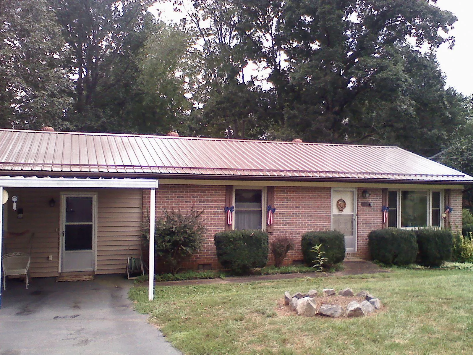 Bronze metal roof and carport on a brick ranch home — Roof Repair work by our crew in Mount Sterling