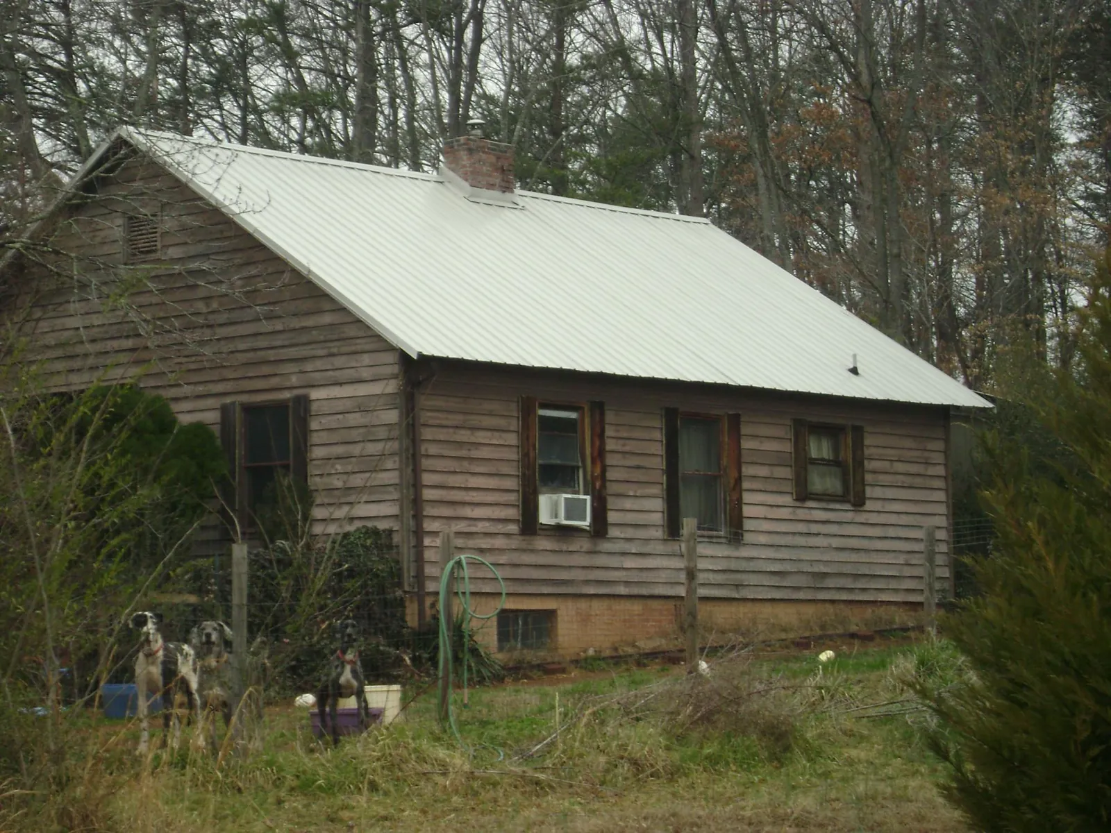 White metal roof on an old wood sided farmhouse, from a Metal Roof Installation job in Mount Sterling